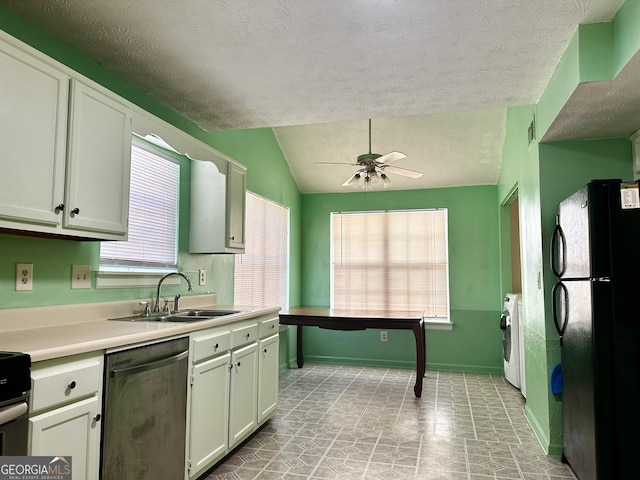 kitchen with washer / clothes dryer, light countertops, white cabinets, a sink, and black appliances