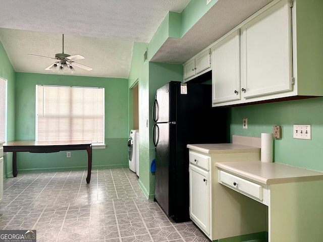 kitchen featuring light countertops, a ceiling fan, washer / dryer, and white cabinets