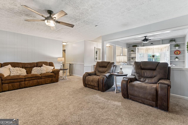 carpeted living room featuring ceiling fan and a textured ceiling