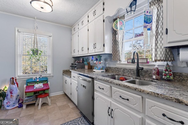 kitchen featuring plenty of natural light, white cabinetry, dishwasher, and a sink