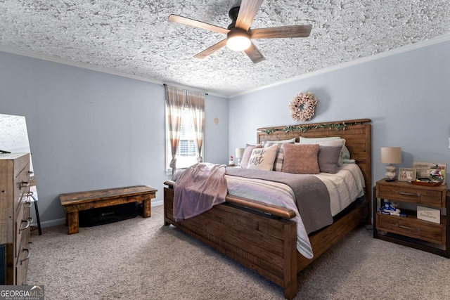 bedroom with a textured ceiling, ceiling fan, carpet flooring, baseboards, and ornamental molding