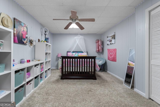 bedroom featuring a paneled ceiling, ceiling fan, and carpet flooring