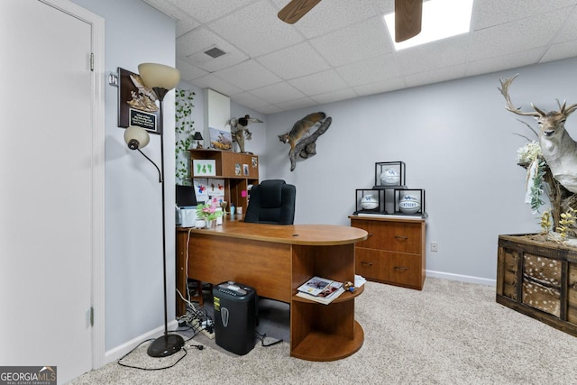 office featuring visible vents, a drop ceiling, light carpet, and baseboards