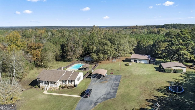 birds eye view of property featuring a view of trees