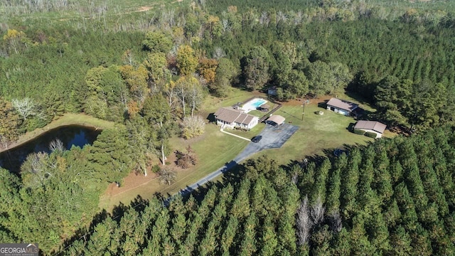 aerial view with a water view and a forest view