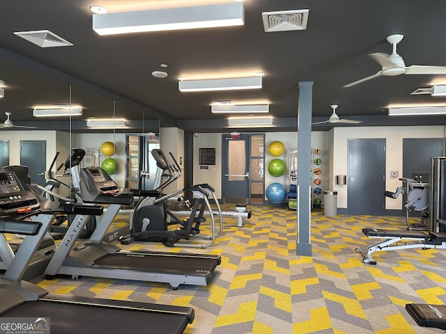 gym featuring a ceiling fan, visible vents, and carpet floors