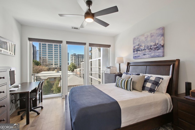775 Juniper St NE Unit 613, Atlanta, GA 30308 - bedroom with wood finished floors, access to outside, a desk, and a ceiling fan