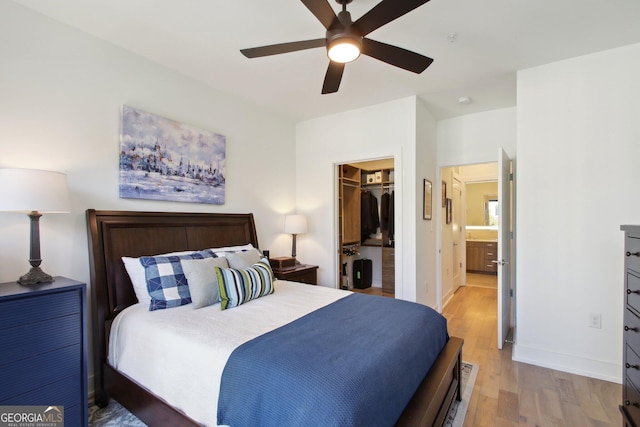 775 Juniper St NE Unit 613, Atlanta, GA 30308 - bedroom with light wood-type flooring, a spacious closet, a ceiling fan, and a closet