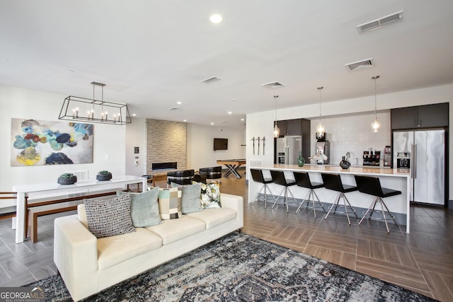 775 Juniper St NE Unit 613, Atlanta, GA 30308 - living area featuring recessed lighting, a fireplace, and a chandelier