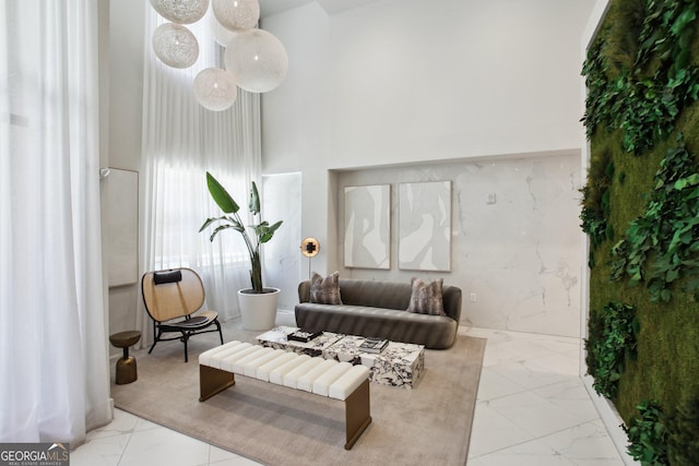 775 Juniper St NE Unit 613, Atlanta, GA 30308 - living room featuring marble finish floors and a high ceiling