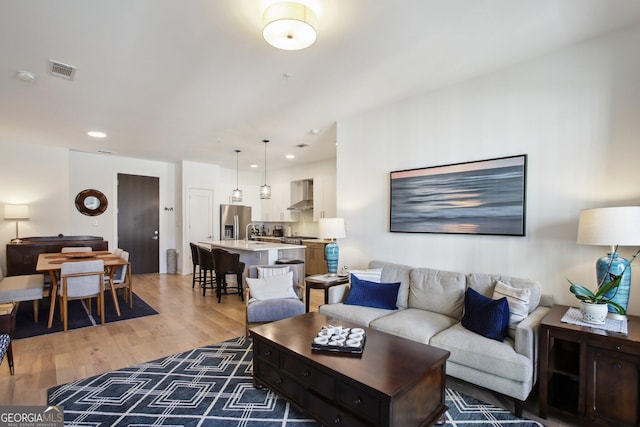 775 Juniper St NE Unit 613, Atlanta, GA 30308 - living area with light wood-type flooring and recessed lighting