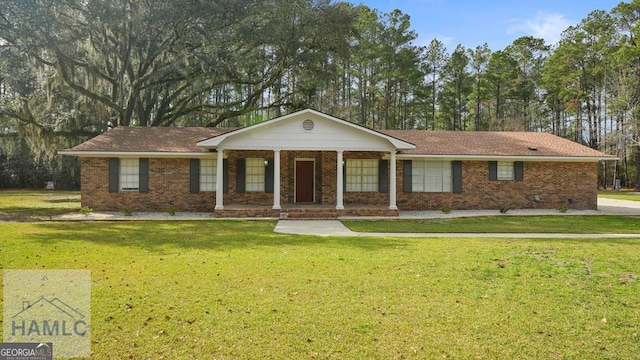 ranch-style house with covered porch, brick siding, and a front yard