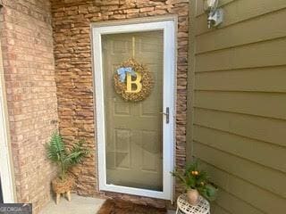 entrance to property featuring brick siding