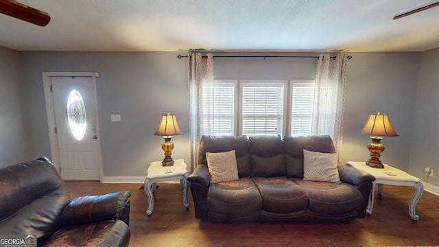 living room featuring baseboards and wood finished floors