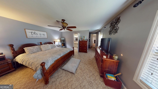 bedroom with ensuite bath and ceiling fan