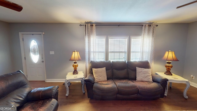 living room featuring baseboards and wood finished floors