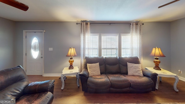 living room with baseboards and wood finished floors