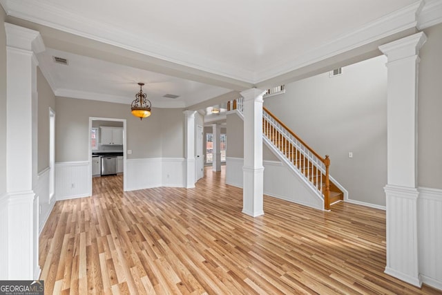 unfurnished living room with stairs, light wood-style flooring, visible vents, and decorative columns