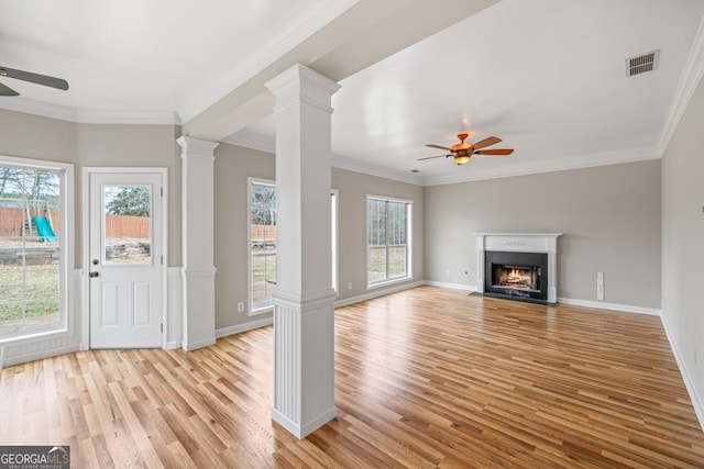 unfurnished living room featuring visible vents, ceiling fan, decorative columns, and light wood-style floors