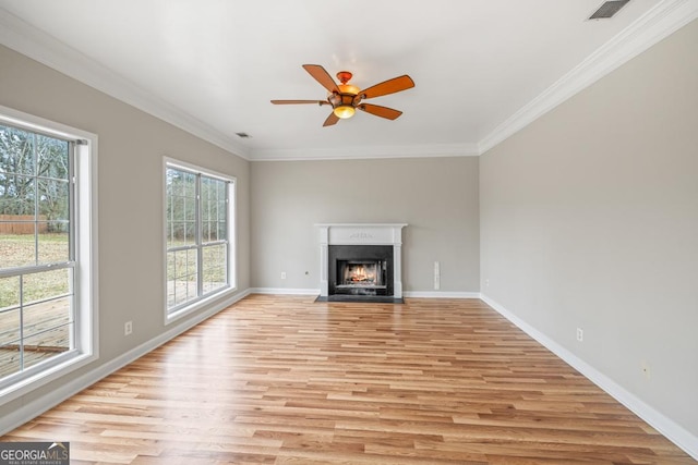 unfurnished living room with a fireplace with flush hearth, light wood-type flooring, visible vents, and crown molding