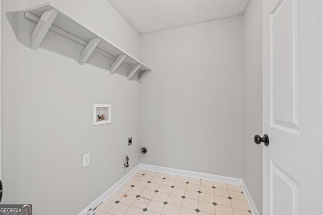 laundry area with laundry area, a textured ceiling, hookup for an electric dryer, light floors, and washer hookup