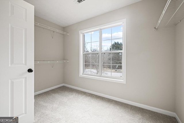 spacious closet with carpet floors and visible vents