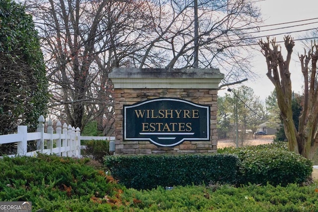 community sign featuring fence