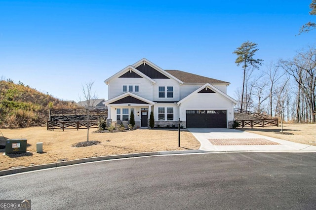 view of front facade with driveway and stone siding