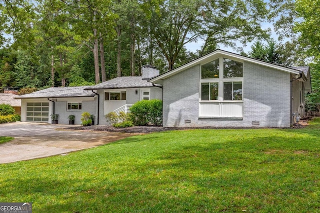 view of front of home featuring brick siding, concrete driveway, crawl space, a front lawn, and a chimney