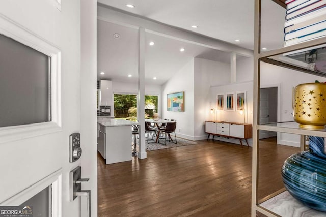 interior space featuring beamed ceiling, recessed lighting, dark wood finished floors, and baseboards