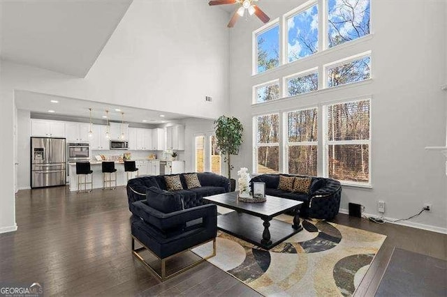 living room with dark wood-style floors, baseboards, a ceiling fan, and recessed lighting