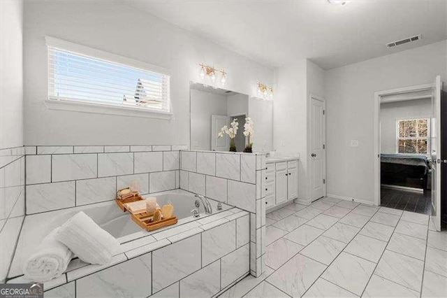 full bathroom featuring baseboards, visible vents, ensuite bath, vanity, and a bath