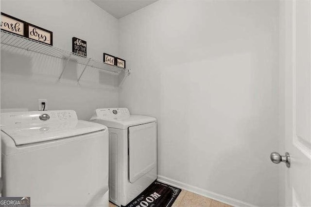 laundry area featuring laundry area, independent washer and dryer, and baseboards