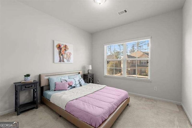 bedroom with light carpet, visible vents, and baseboards