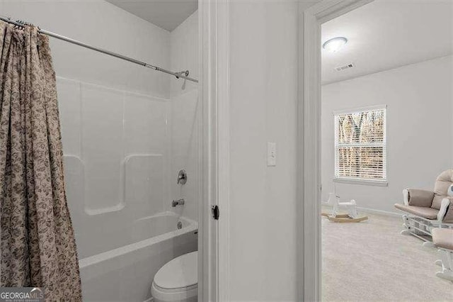 full bath with toilet, visible vents, and shower / bath combo with shower curtain