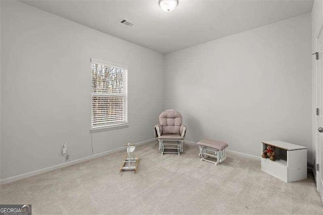 sitting room with light carpet, visible vents, and baseboards