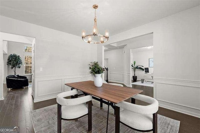 dining room featuring a notable chandelier, dark wood-style flooring, and wainscoting