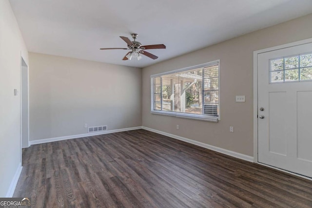 foyer entrance featuring baseboards, dark wood-style flooring, visible vents, and a healthy amount of sunlight