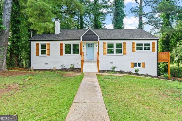 single story home with crawl space, brick siding, a chimney, and a front yard