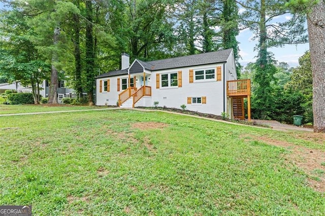 ranch-style home with a deck, a front yard, a chimney, and stairway