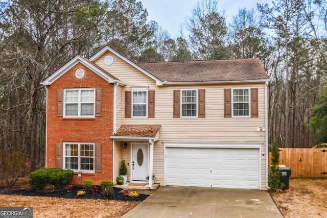 view of front of home with roof with shingles, brick siding, fence, a garage, and driveway