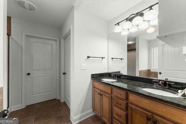 full bathroom with tile patterned floors, visible vents, a sink, and double vanity