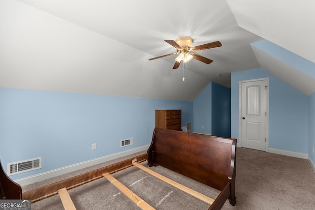 carpeted bedroom with visible vents, vaulted ceiling, baseboards, and ceiling fan