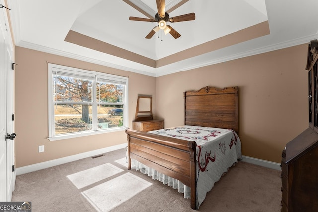 bedroom featuring a tray ceiling, light colored carpet, and baseboards