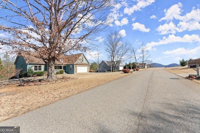 view of street featuring a residential view and a mountain view