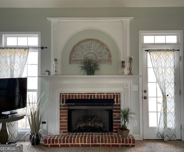 interior space featuring carpet and a brick fireplace