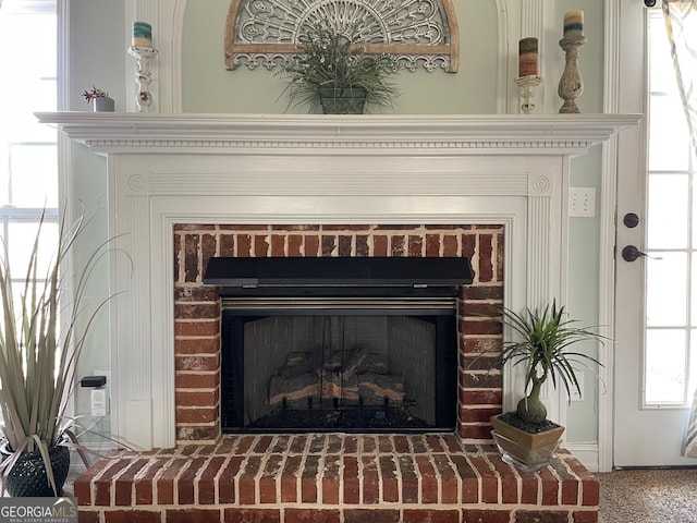 interior details with a brick fireplace