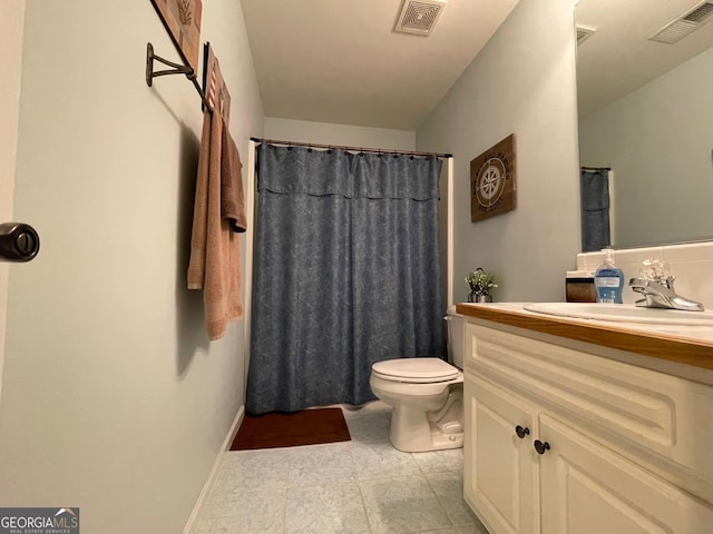 bathroom with visible vents, vanity, and toilet