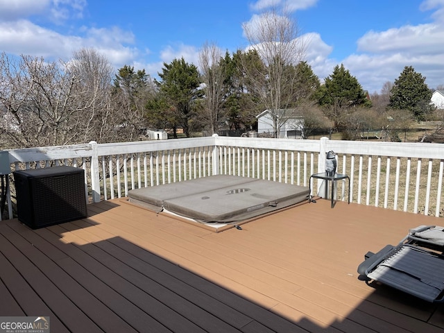 wooden terrace with a covered hot tub