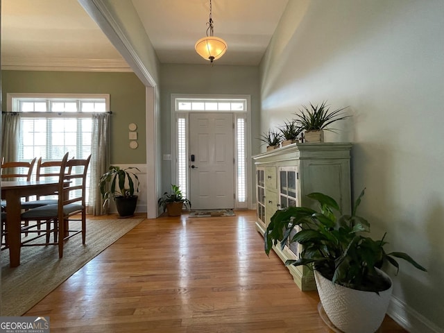 entrance foyer featuring light wood-style flooring and baseboards